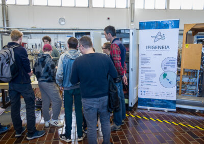 Visitors gathered around IFIGENEIA project presentation stand at Jožef Stefan Institute Open Day (photo: Marjan Verč, 2026)