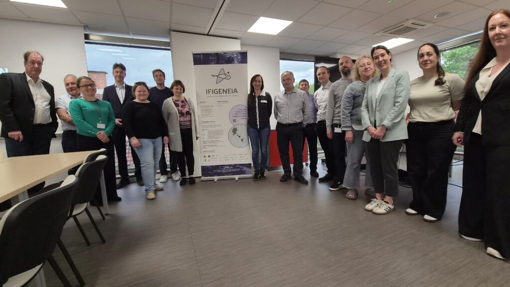 IFIGENEIA project coordinator and Slovenian partners during a project meeting beside the IFIGENEIA banner