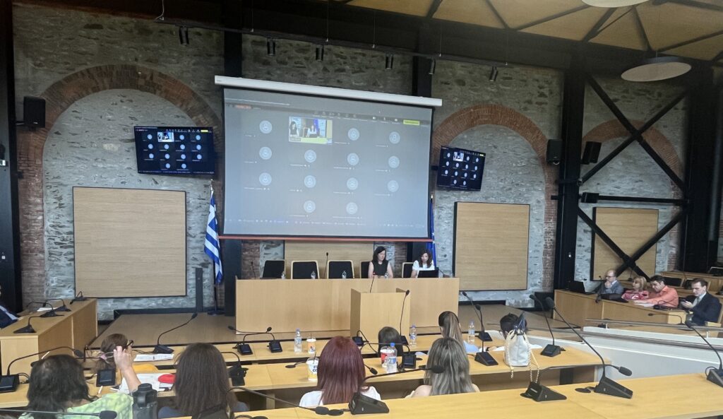 Participants attending the Open Ecosystem Event “Central Macedonia as a Digital Health Experimentation Hub”, with speakers at the front and online participants joining remotely.