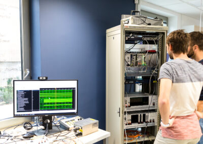 Researchers working with particle accelerator control and monitoring equipment at Cosylab.